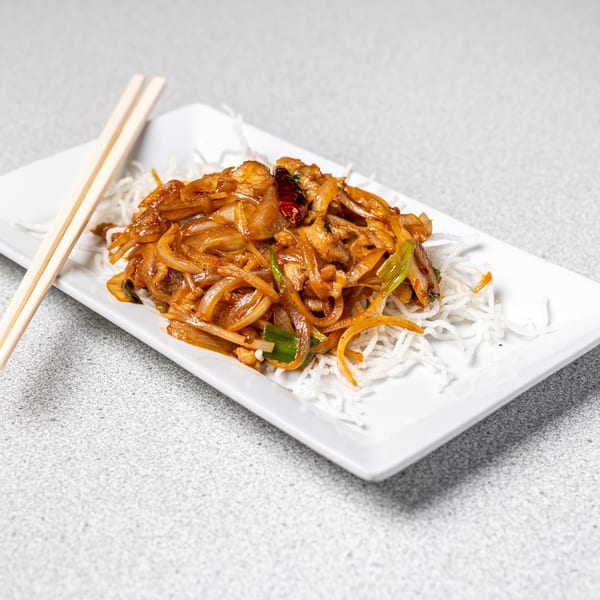 Peking Restaurant's stir-fried onions and meat with chili on a bed of crispy noodles, with chopsticks.