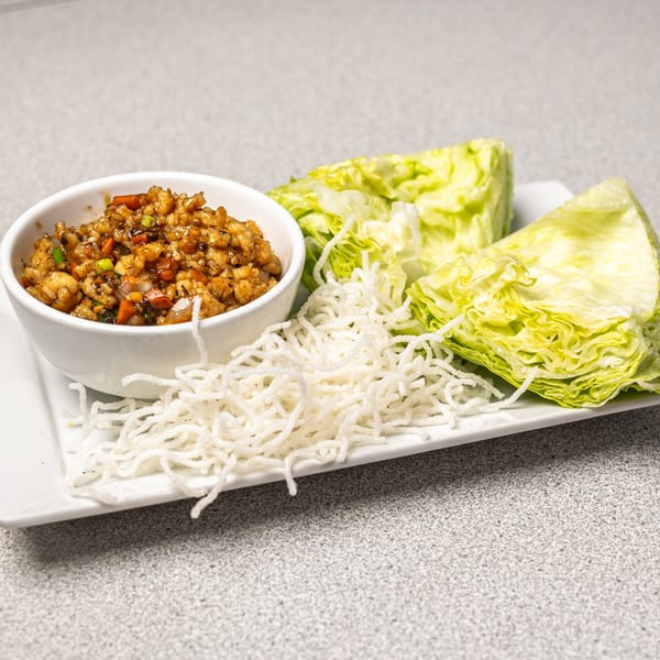 Peking Restaurant's lettuce wraps with a bowl of savory filling, crispy noodles, and fresh lettuce.
