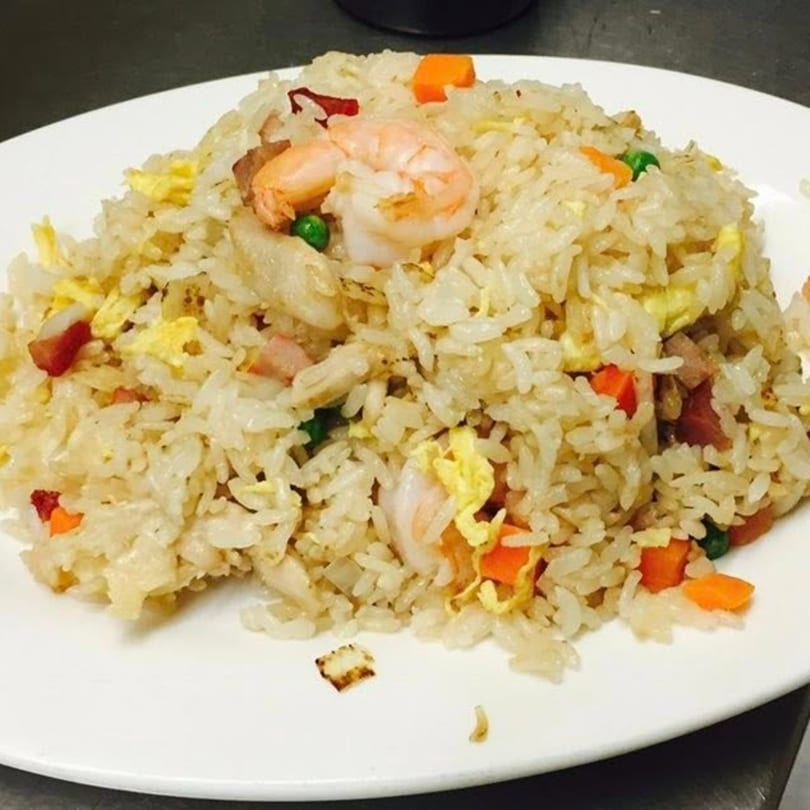 Peking Restaurant's shrimp fried rice with peas, carrots, and scrambled egg on a white plate.