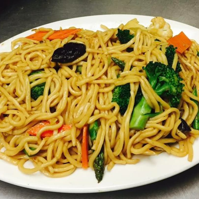 Peking Restaurant's vegetable lo mein with noodles, broccoli, carrots, and mushrooms on a white plate.