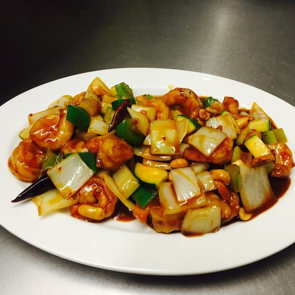 Kung Pao shrimp with onions, green peppers, zucchini, and peanuts in a rich sauce.